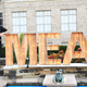 Guy Fieri standing beside giant sign reading "MEAT"